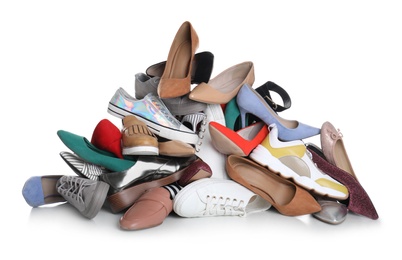 Photo of Pile of female shoes on white background