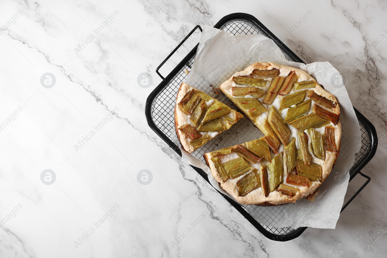 Photo of Freshly baked rhubarb pie on white marble table, top view. Space for text