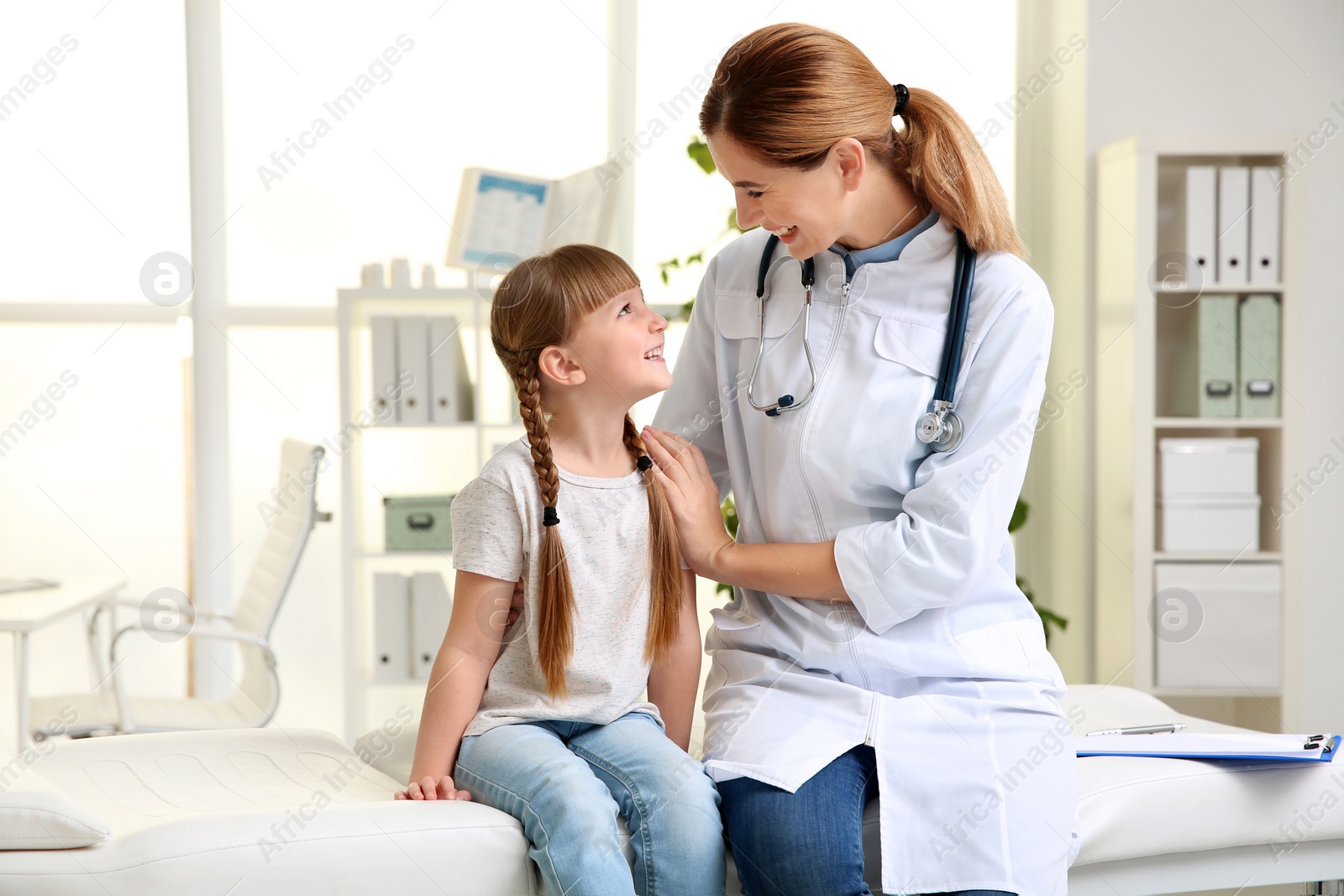 Photo of Doctor working with little patient in hospital