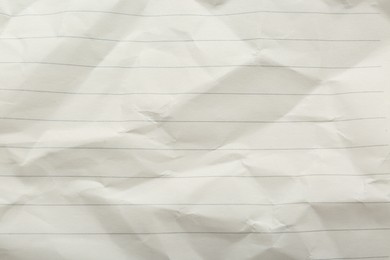 Photo of Crumpled lined notebook sheet as background, top view