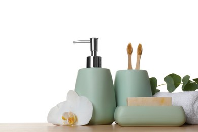 Photo of Bath accessories. Different personal care products, flower and eucalyptus branch on wooden table against white background. Space for text