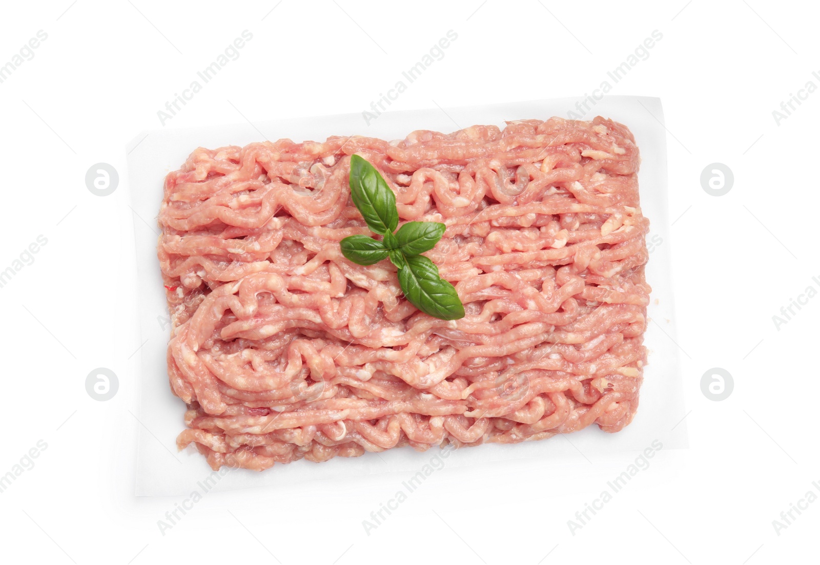 Photo of Raw chicken minced meat with basil on white background, top view