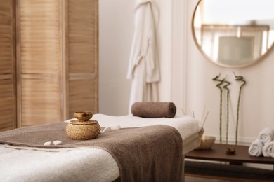 Photo of Stylish room interior with massage table in spa salon