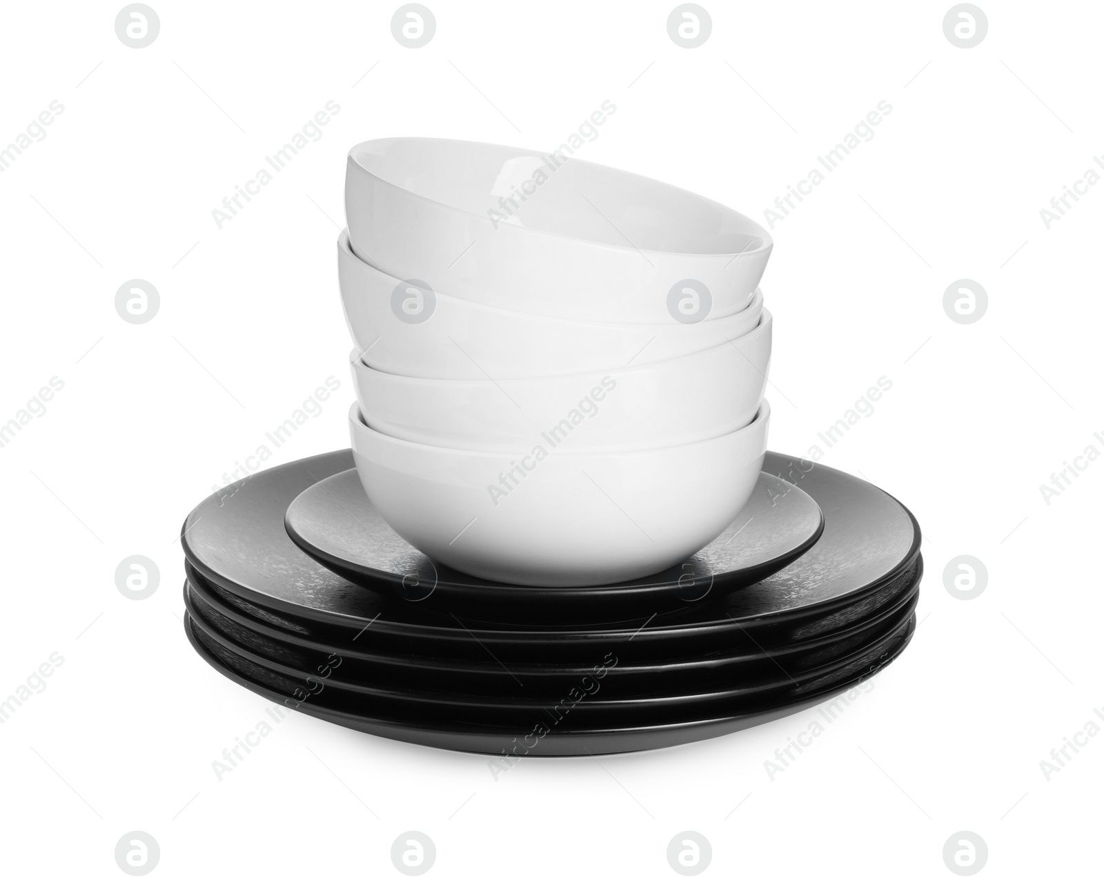 Photo of Stack of beautiful ceramic plates and bowls isolated on white