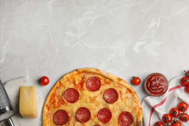 Flat lay composition with tasty pepperoni pizza on light grey marble table. Space for text