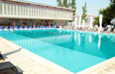Photo of Blurred view of clean swimming pool on sunny day