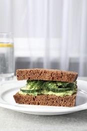 Tasty sandwich with cucumber, cream cheese and dill on grey table indoors. Space for text