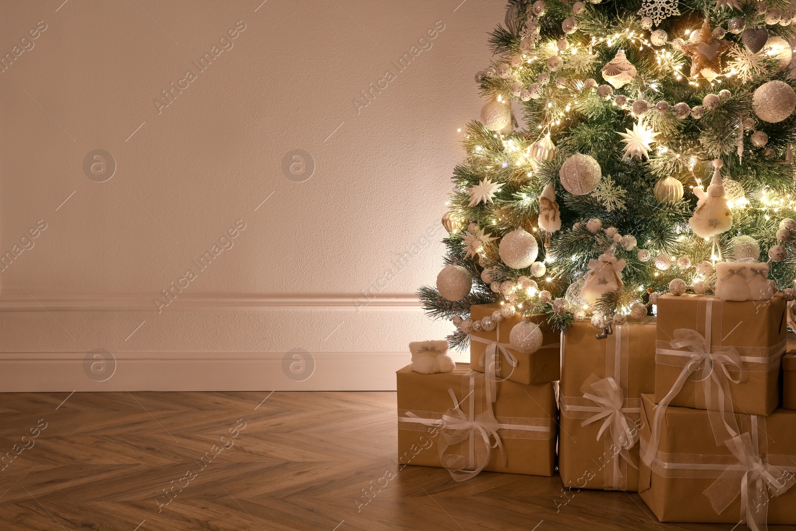 Photo of Beautiful decorated Christmas tree and gifts indoors. Space for text