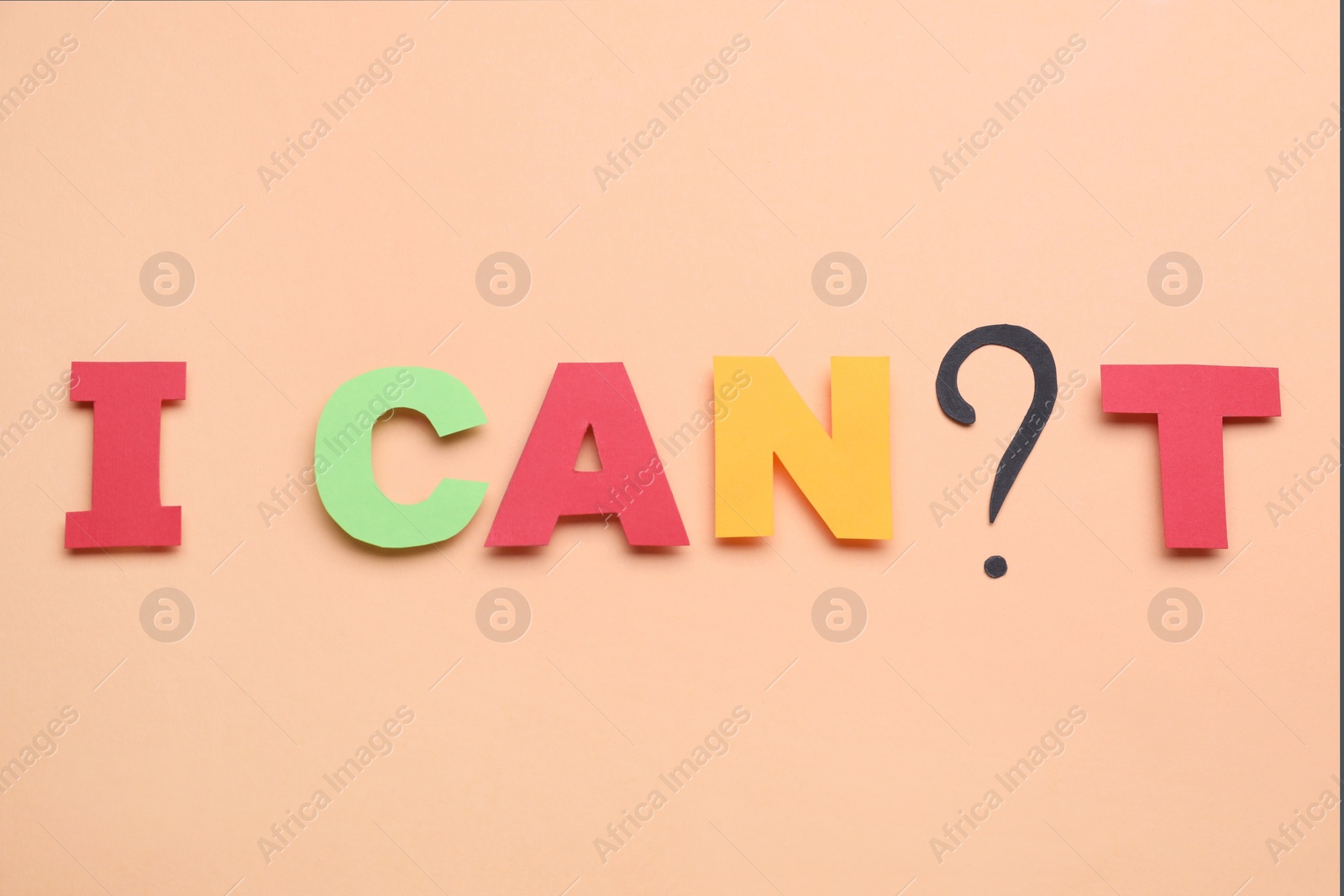 Photo of Phrase I Can`t with question mark and letters made of paper on beige background, top view. Motivation concept