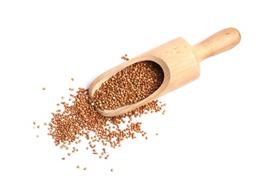 Photo of Scoop with uncooked buckwheat on white background, top view