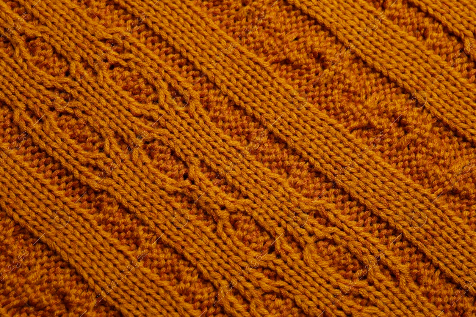 Photo of Beautiful orange knitted fabric as background, top view