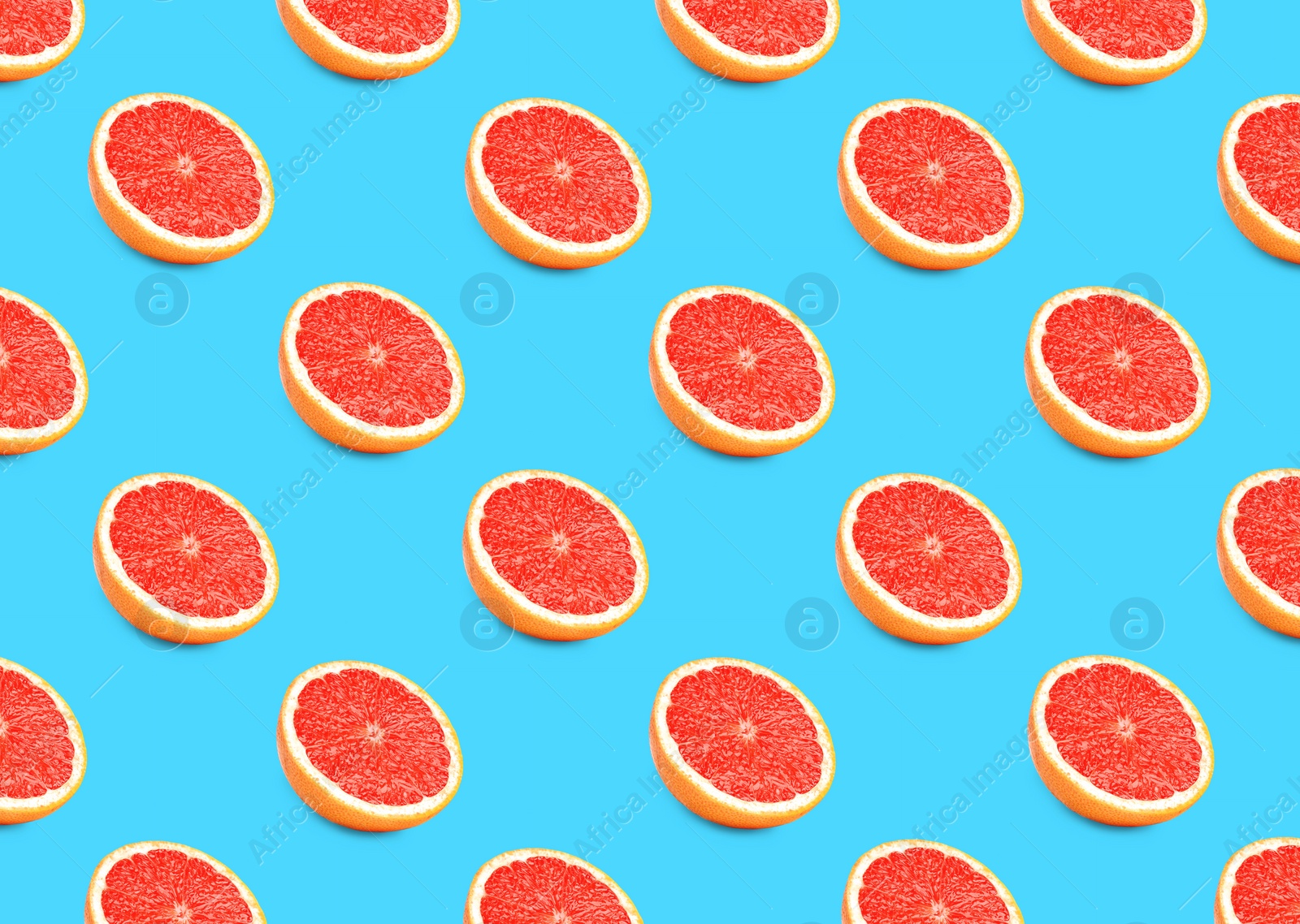 Image of Many fresh ripe grapefruits on turquoise background. Seamless pattern design