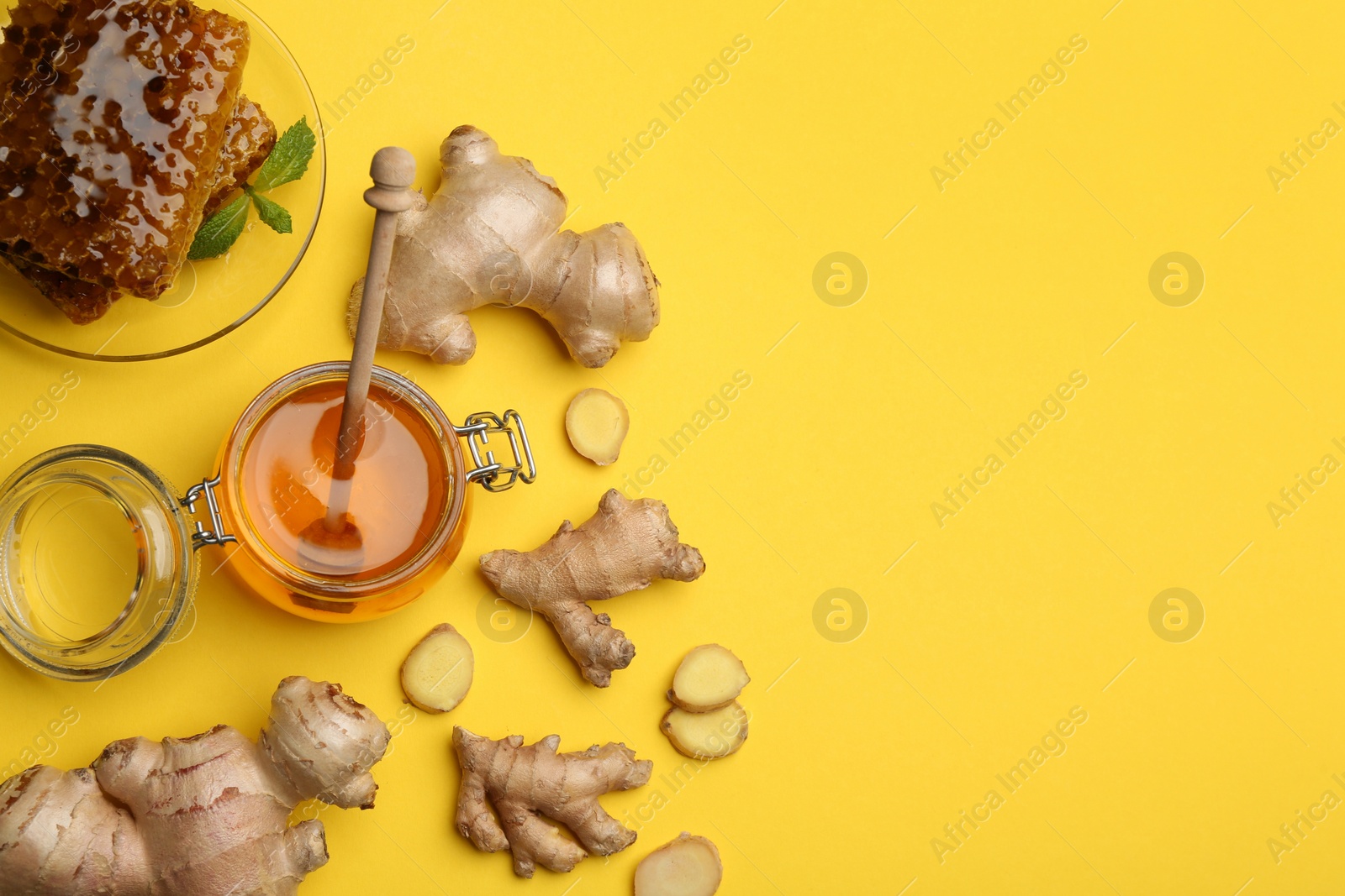 Photo of Ginger and honey on yellow table, flat lay with space for text. Natural cold remedies