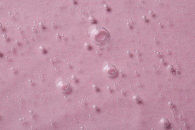 Photo of Cosmetic serum on pink background, top view