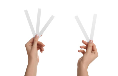 Woman holding perfume testing strips on white background, closeup of hands