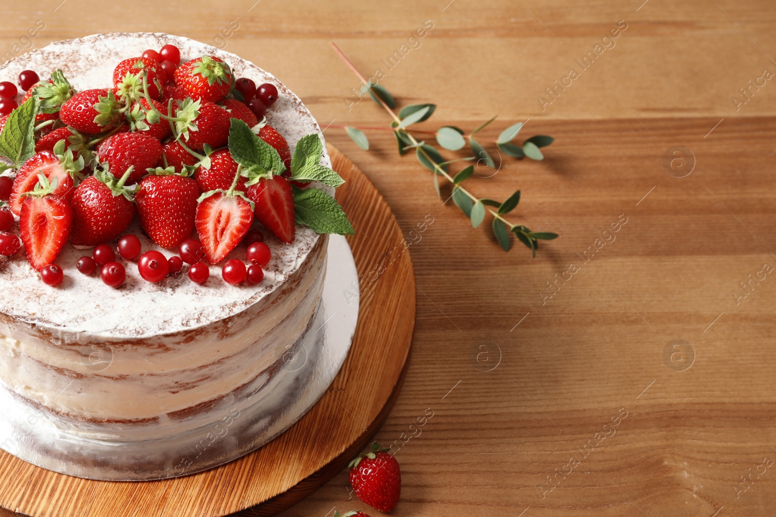 Photo of Delicious homemade cake with fresh berries and space for text on wooden table