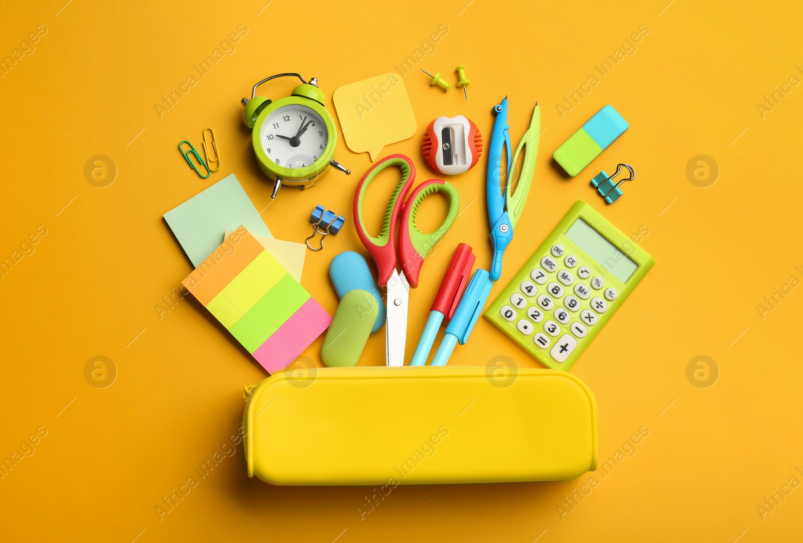 Photo of Flat lay composition with school stationery on orange background. Back to school