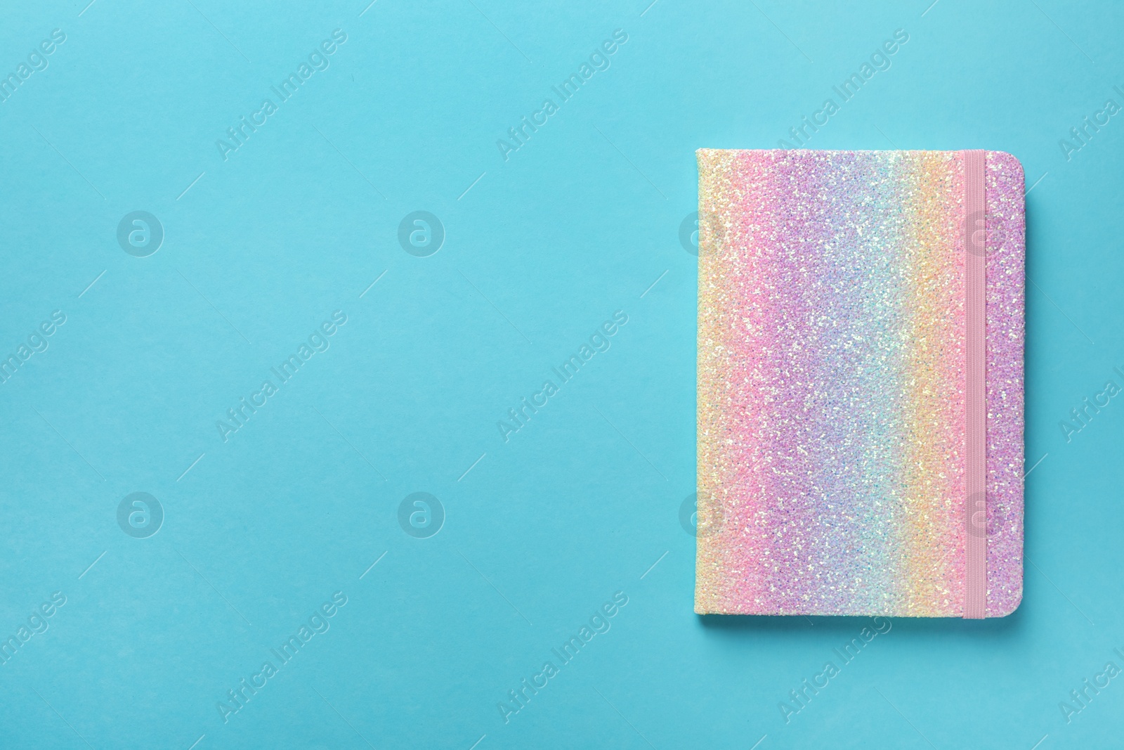 Photo of New stylish planner on light blue background, top view. Space for text