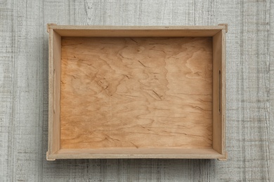 Photo of Empty crate on wooden background, top view