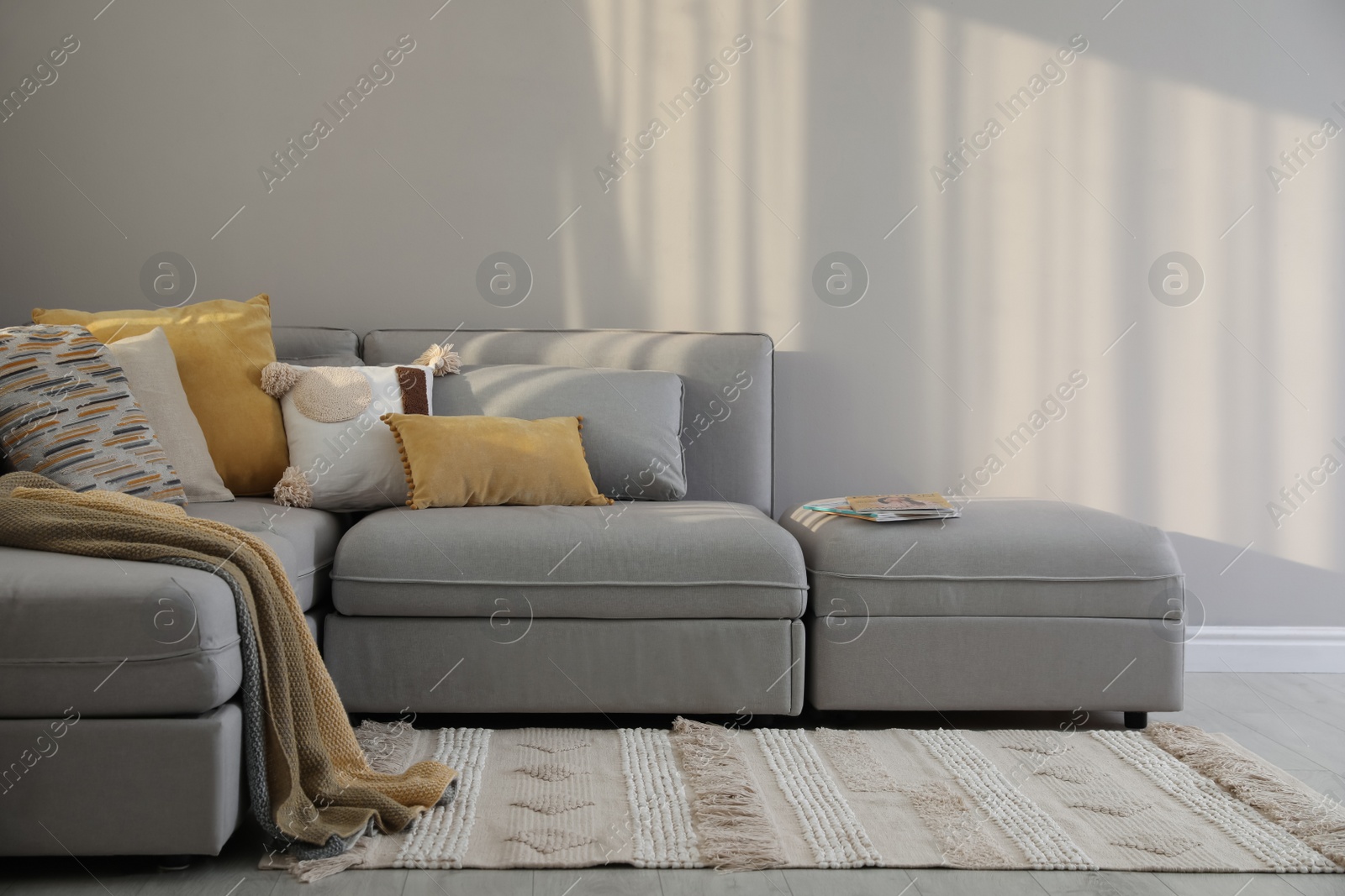 Photo of Living room interior with large grey sofa