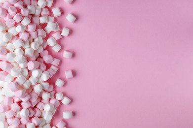 Photo of Delicious marshmallows on pink background, flat lay. Space for text