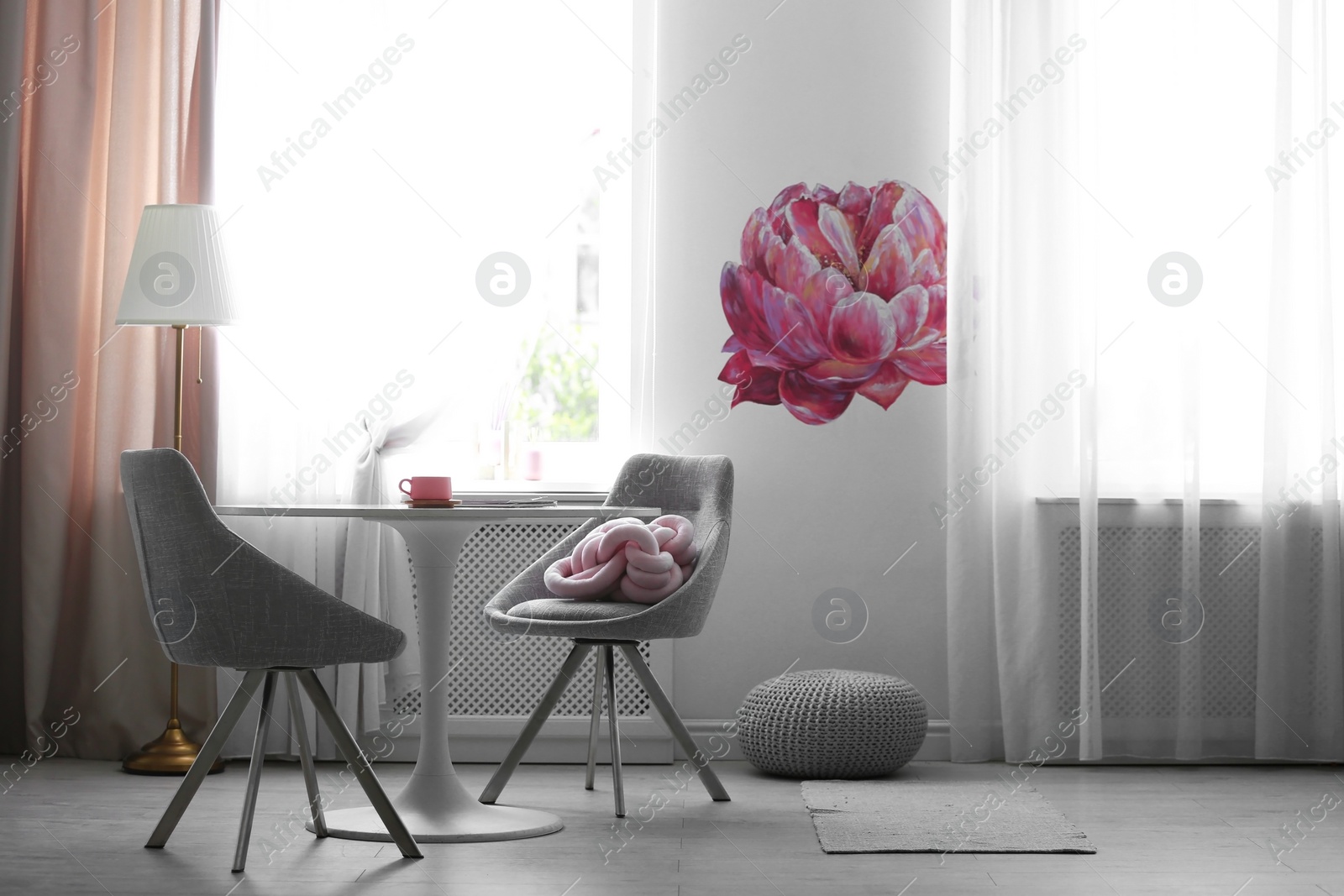 Photo of Stylish room interior with table and chairs near decorated wall