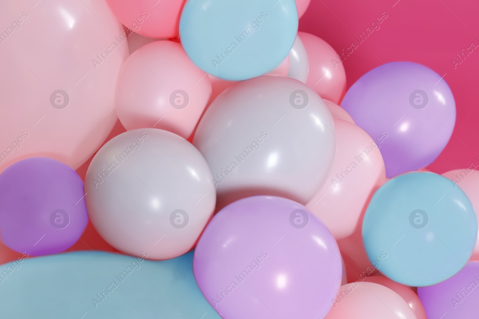 Image of Beautiful colorful balloons on pink background, closeup. Party decor 