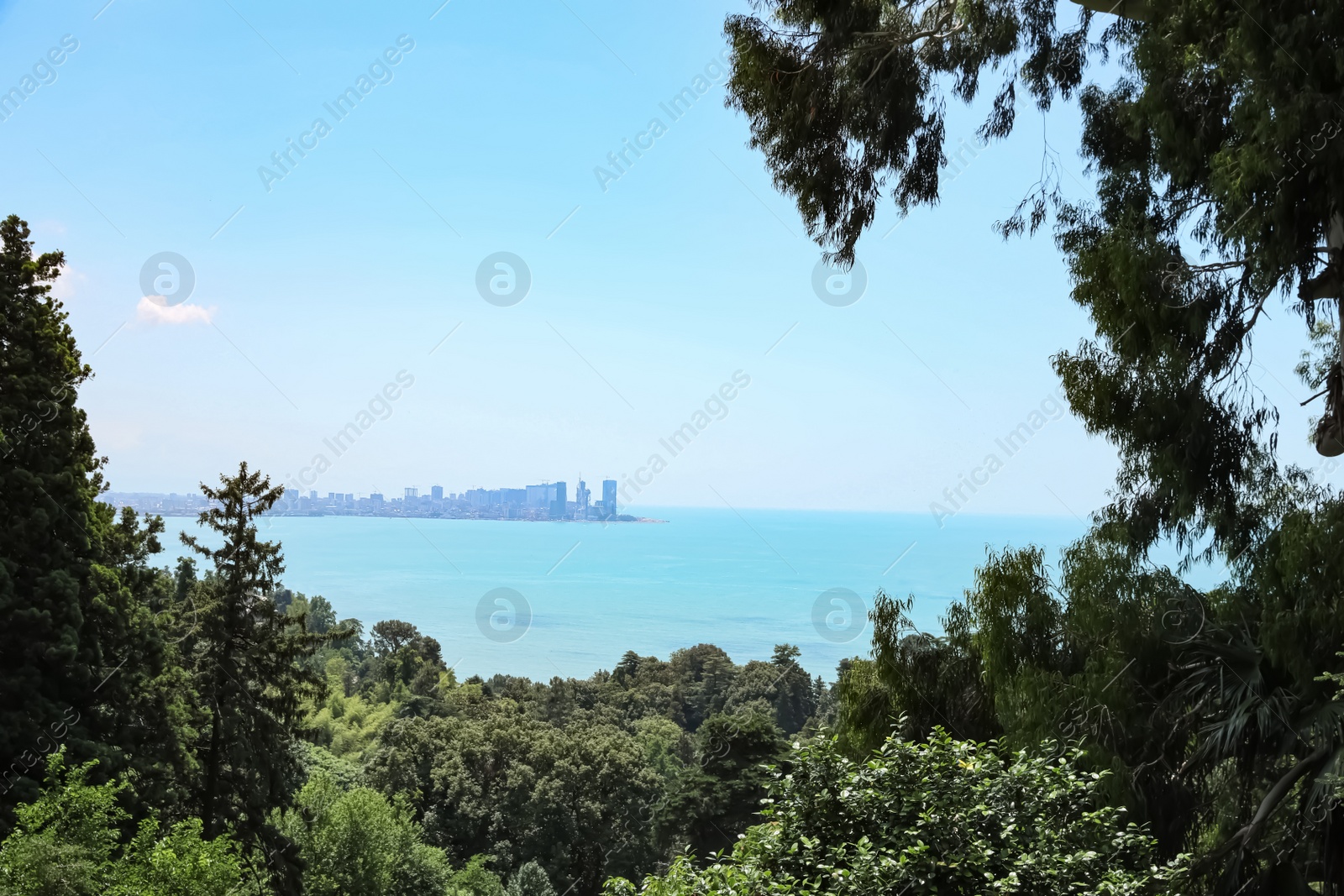 Photo of Picturesque view of beautiful sea and distant city on sunny day
