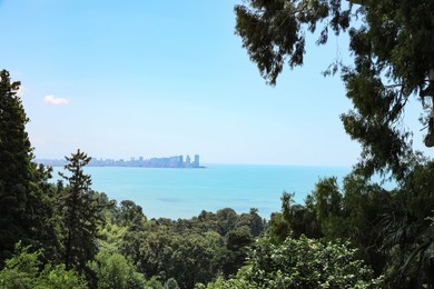 Picturesque view of beautiful sea and distant city on sunny day