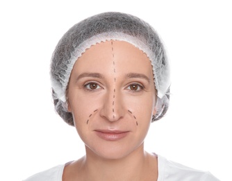 Portrait of woman with marks on face preparing for cosmetic surgery against white background