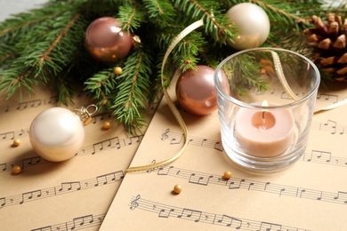Photo of Composition with Christmas decorations on music sheets, closeup