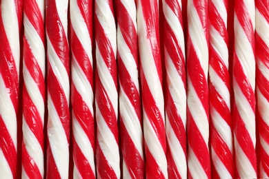 Photo of Candy canes as background, closeup. Traditional Christmas treat