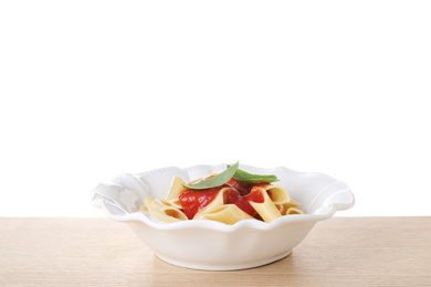 Photo of Delicious maltagliati pasta with tomato sauce on wooden table