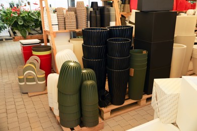 Photo of Many different flower pots in gardening shop