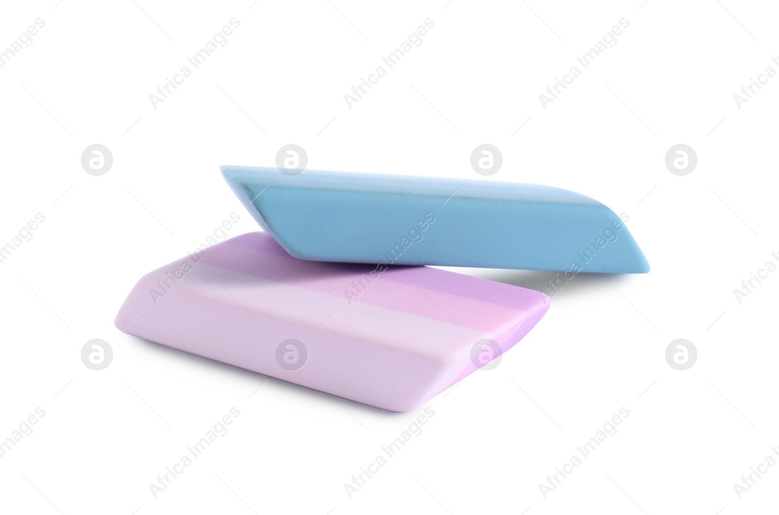 Photo of New bright erasers isolated on white. School stationery