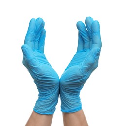 Doctor wearing light blue medical gloves holding something on white background, closeup