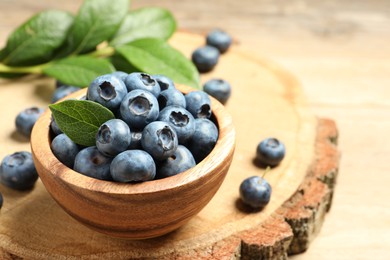 Photo of Bowl of fresh tasty blueberries on table, closeup. space for text