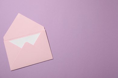 Letter envelope with card on violet background, top view. Space for text