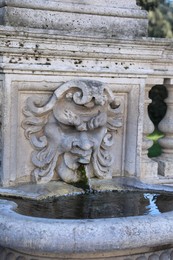 Rome, Italy - February 3, 2024: Gargoyle with moustache spitting water near Villa Borghese