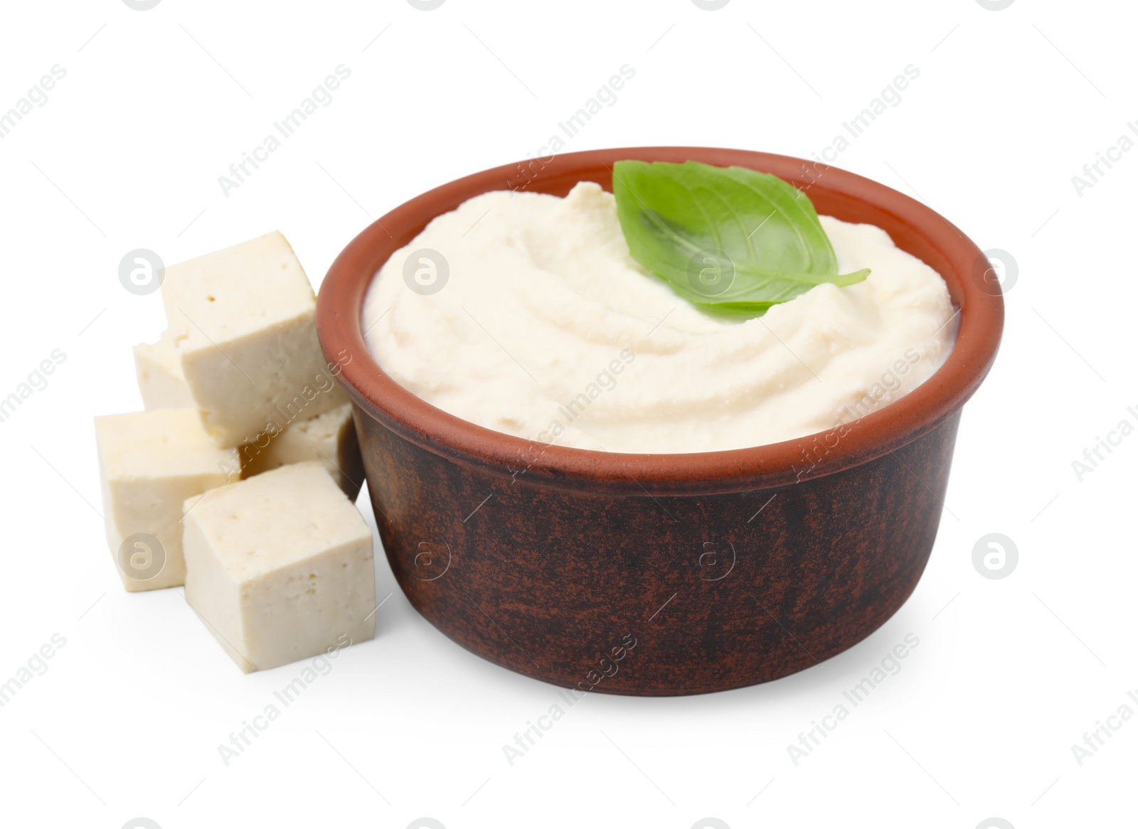 Photo of Delicious tofu, sauce and basil leaf in bowl isolated on white