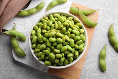 Photo of Organic edamame beans on light grey table, flat lay
