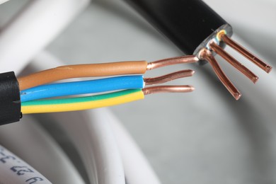 Photo of Colorful electrical wires on blurred background, closeup