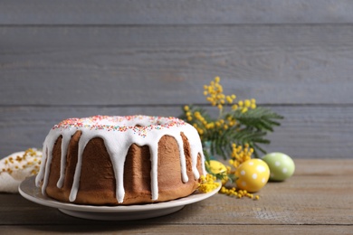 Glazed Easter cake with sprinkles on wooden table, space for text