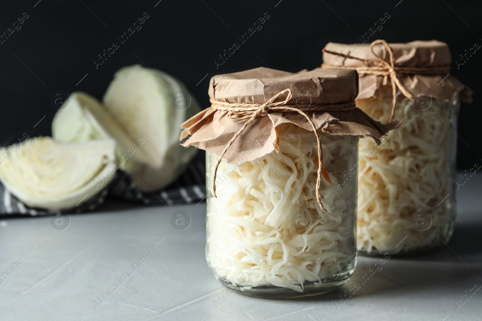 Photo of Tasty fermented cabbage on light grey table