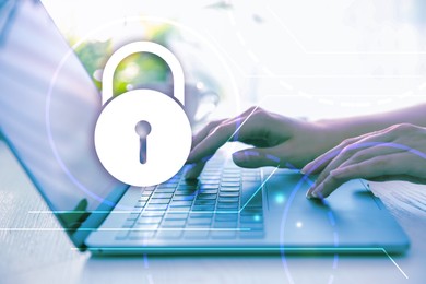 Image of Cyber security concept. Illustration of lock and woman working with laptop at table, closeup