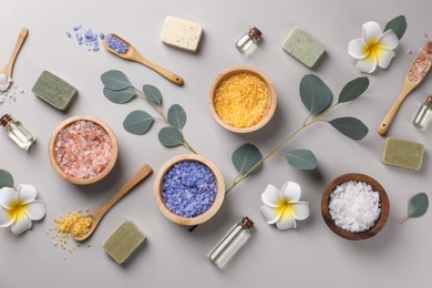 Photo of Flat lay composition with spa products and eucalyptus branches on grey background