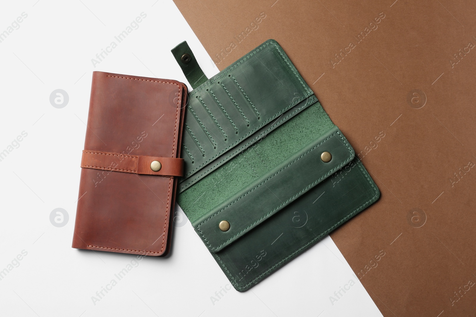 Photo of Stylish wallets on color background, top view