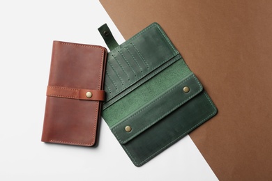 Stylish wallets on color background, top view