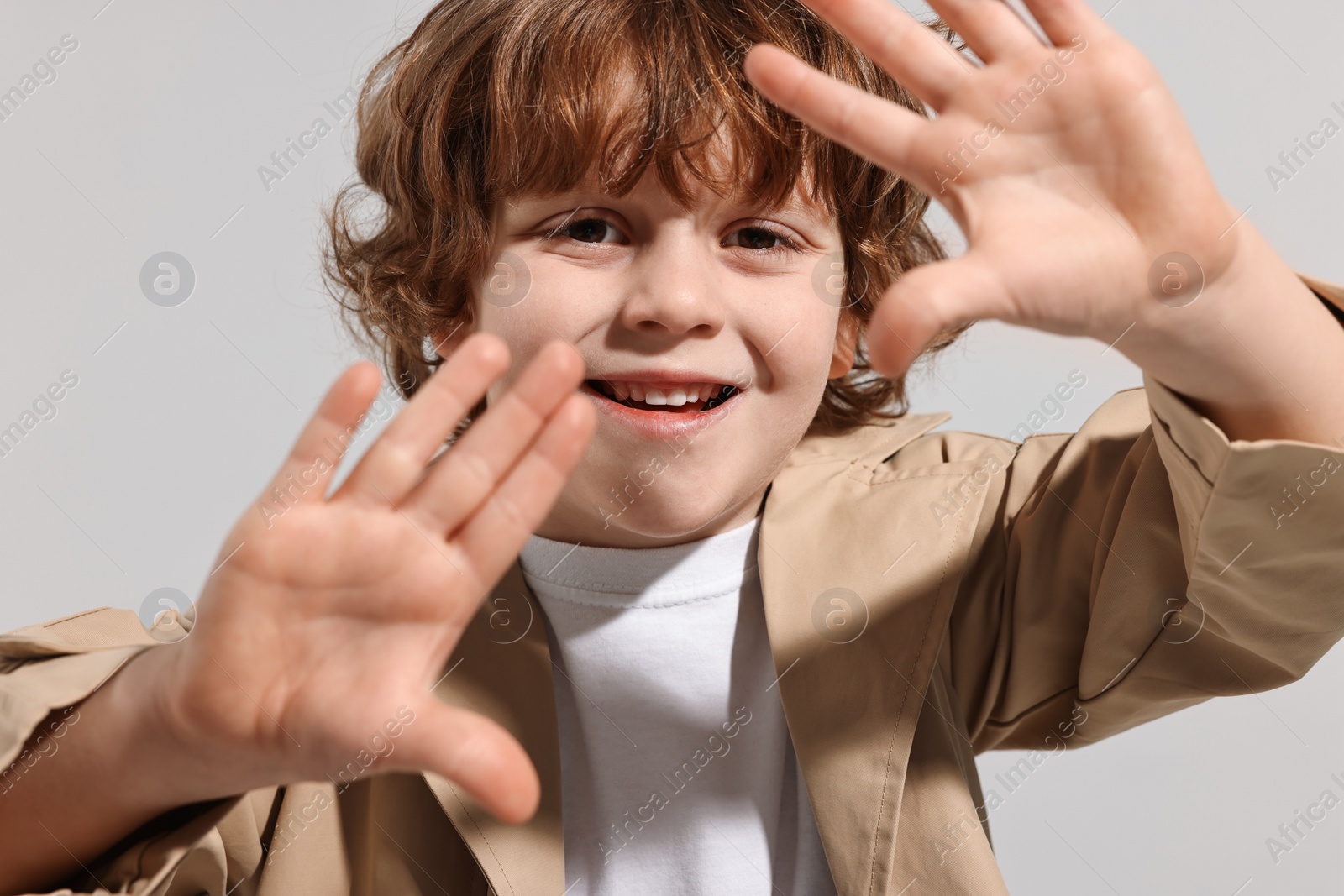 Photo of Fashion concept. Stylish boy posing on light grey background