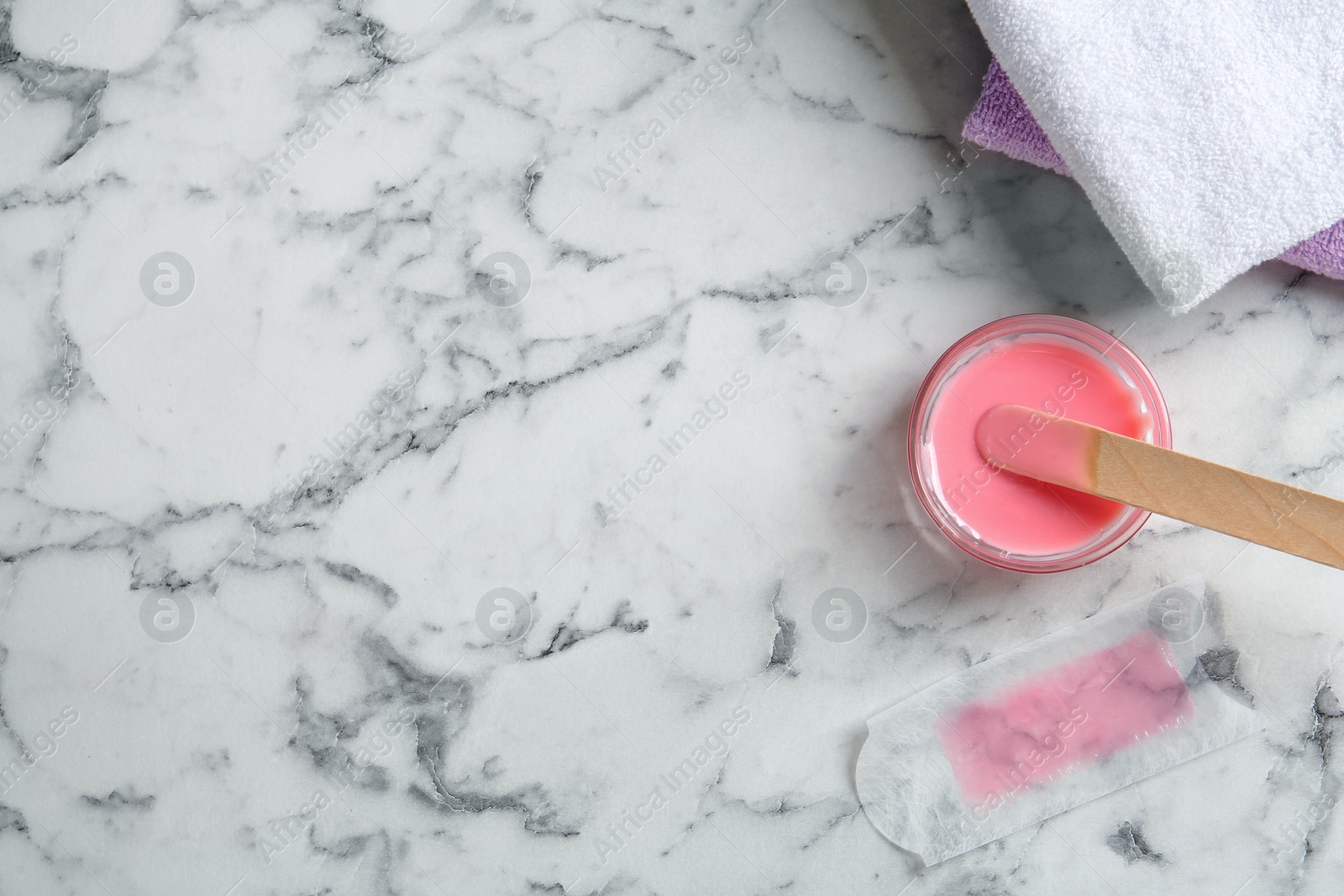 Photo of Flat lay composition with wax and spatula on white marble table. Space for text